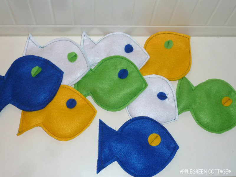 finished diy fish made from blue, white and green felt with corn stuffing