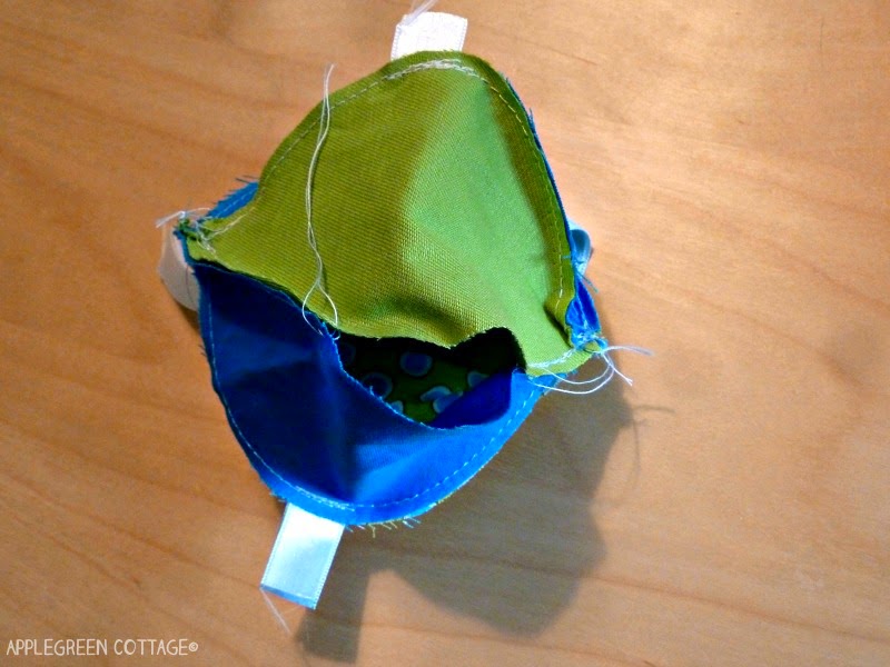 sewing blue and green fabric ball