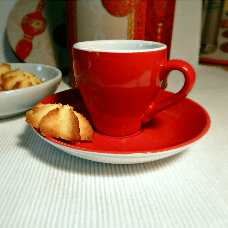 baked christmas coconut cookie red coffee cup with a coconut cookie on a plate