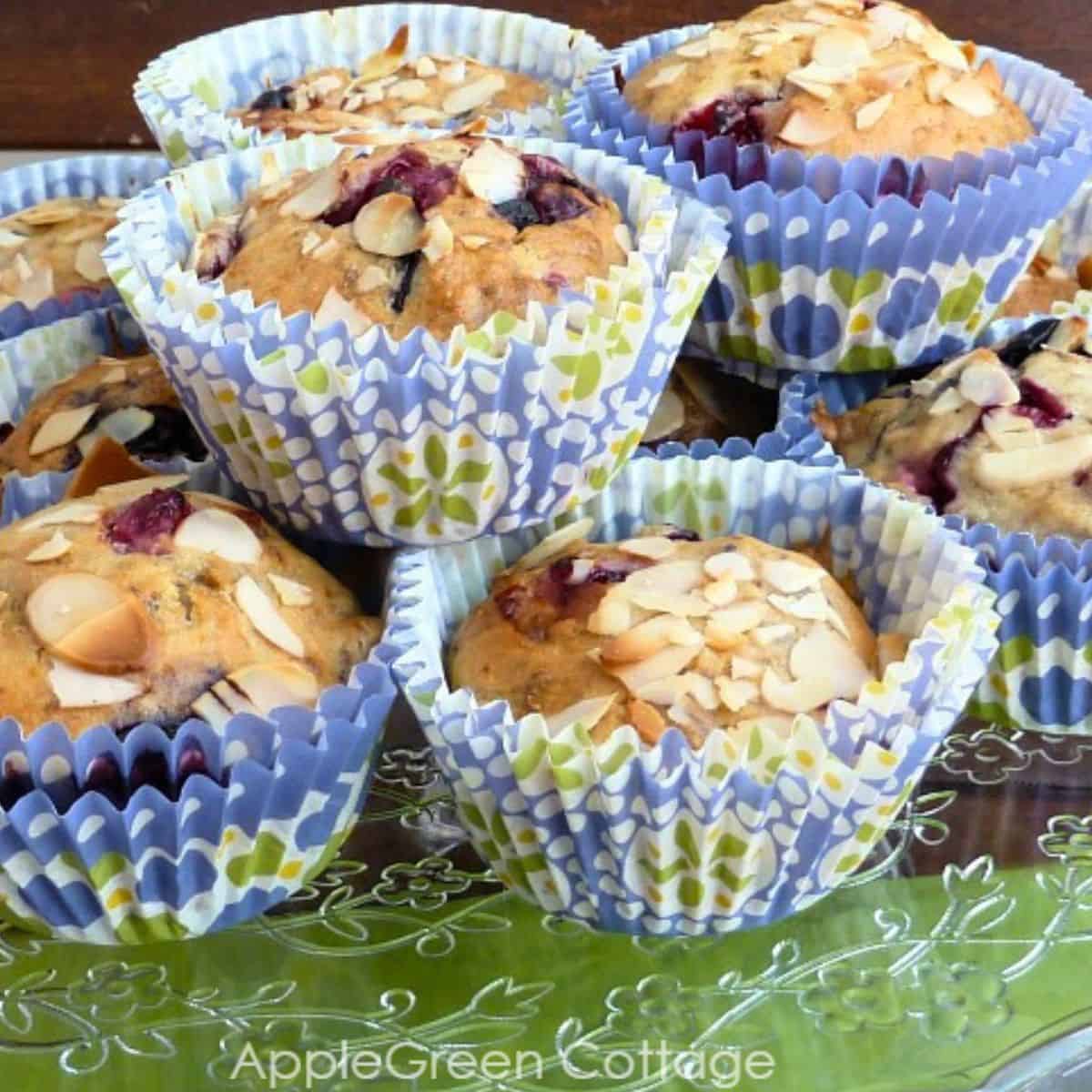 a fresh baked plate of vegan berry mufins made with frozen berries