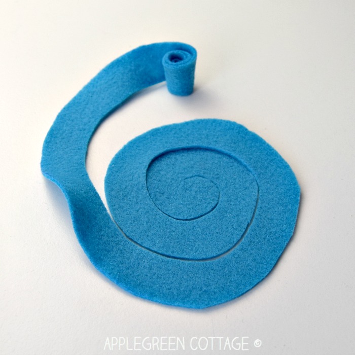 rolled end of a blue felt strip