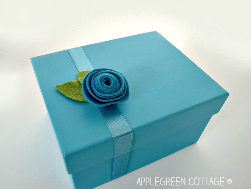 rolled flower glued on a box as a gift topper