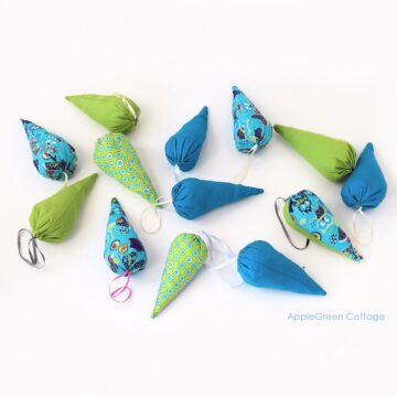 little cone-shaped fabric ornaments in green and blue for a Christmas tree
