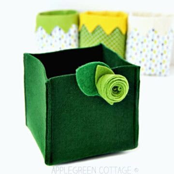 A finished green felt box sewn with just 4 seams, and with a felt decoration.
