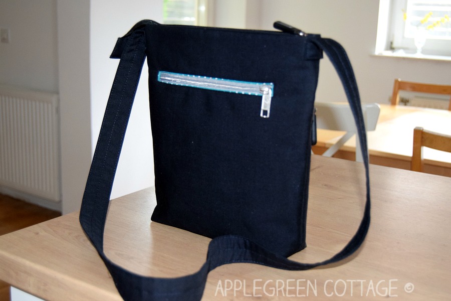 black diy crossbody bag on a wooden table in a house