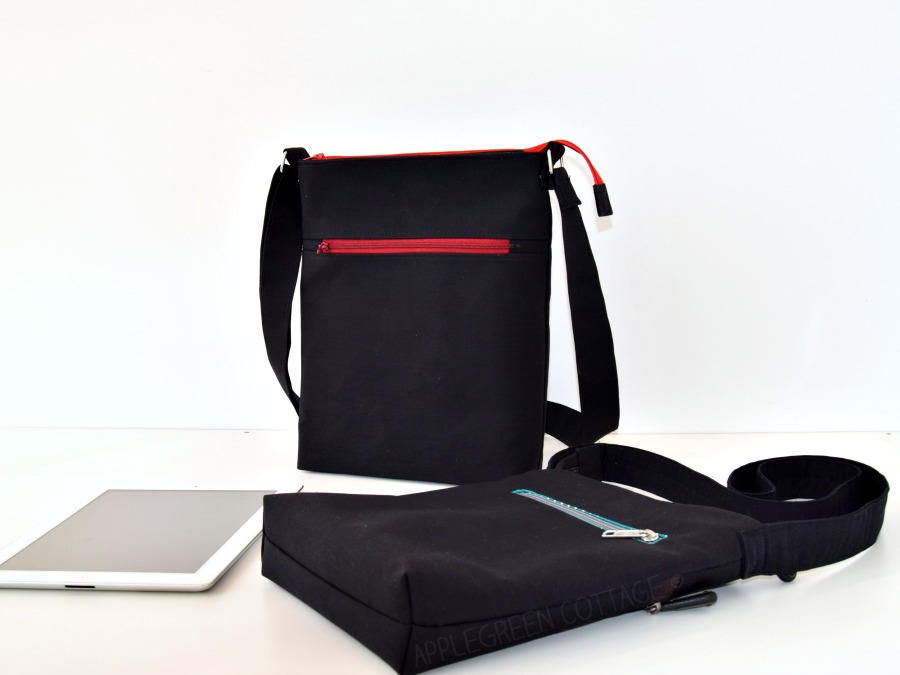 two black crossbody bags on a white surface