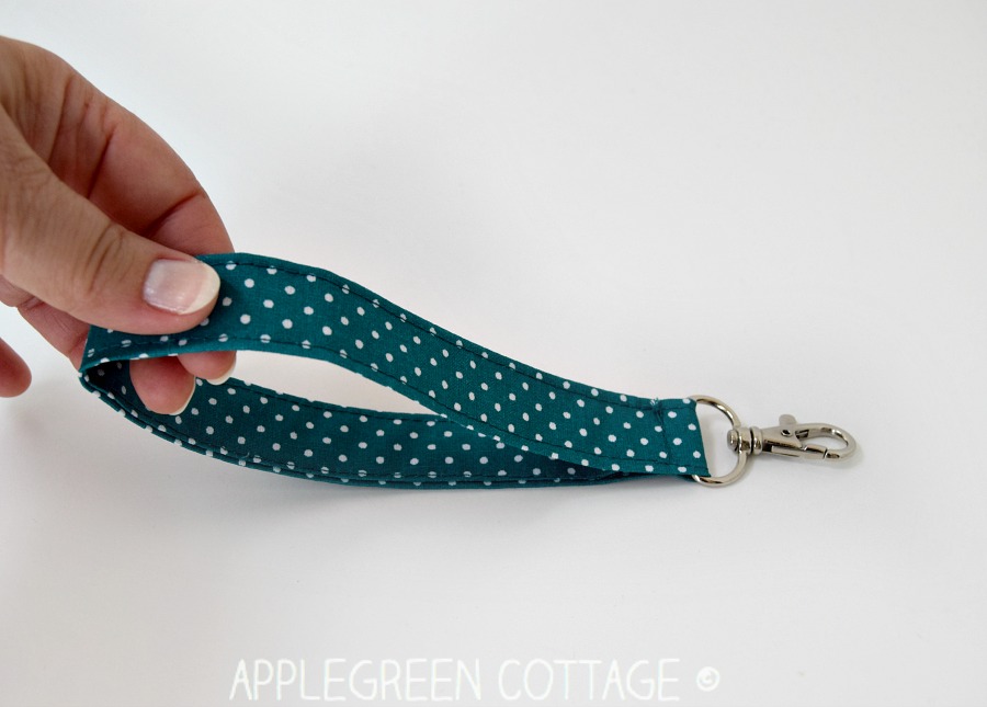 hand holding a wristlet strap