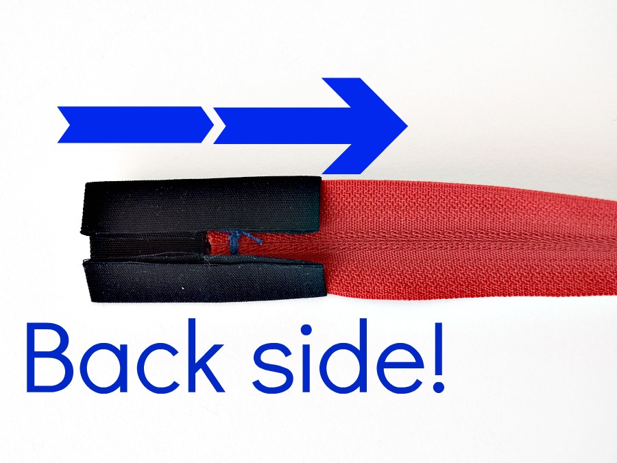 a folded piece of fabric being added to a free zipper end 