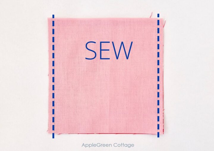 A pink fabric square with dashed lines marking the seam allowance for quilting a four-patch block.
