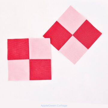 Two completed four-patch quilt blocks with pink and red fabric in a grid pattern on a white background.
