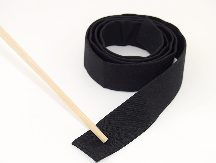 a finished black bag strap shown on a white surface