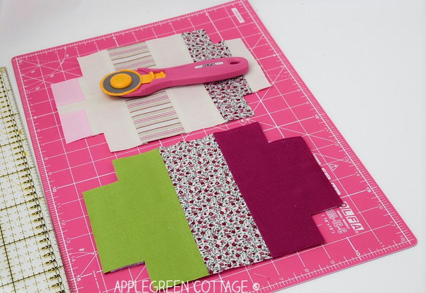 fabric on the cutting mat next to a rotary cutter