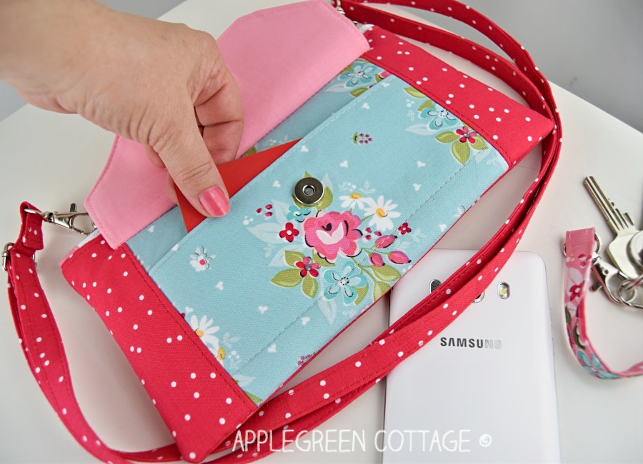 a small-sized floral bag in red and blue with a magnetic snap closure