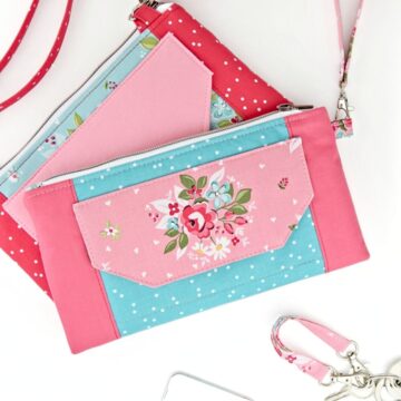 two finished handpurses in pink prints with flaps and crossbody straps