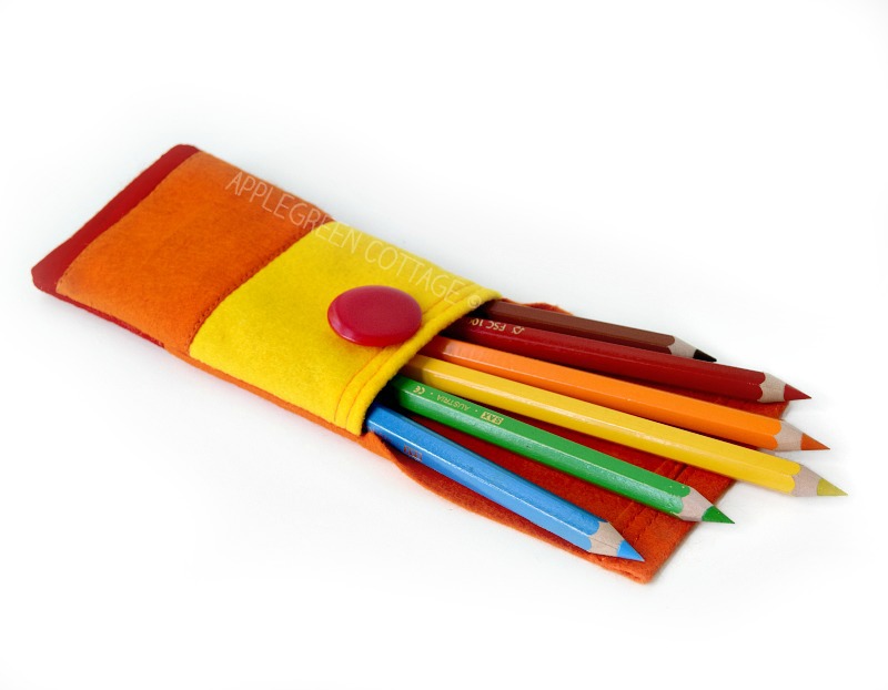 a finished felt pencil pocket filled with colored pencils