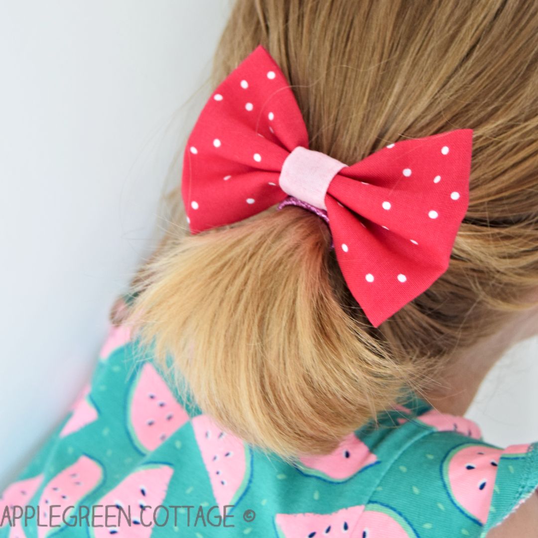 red diy hair bow on a girls head 