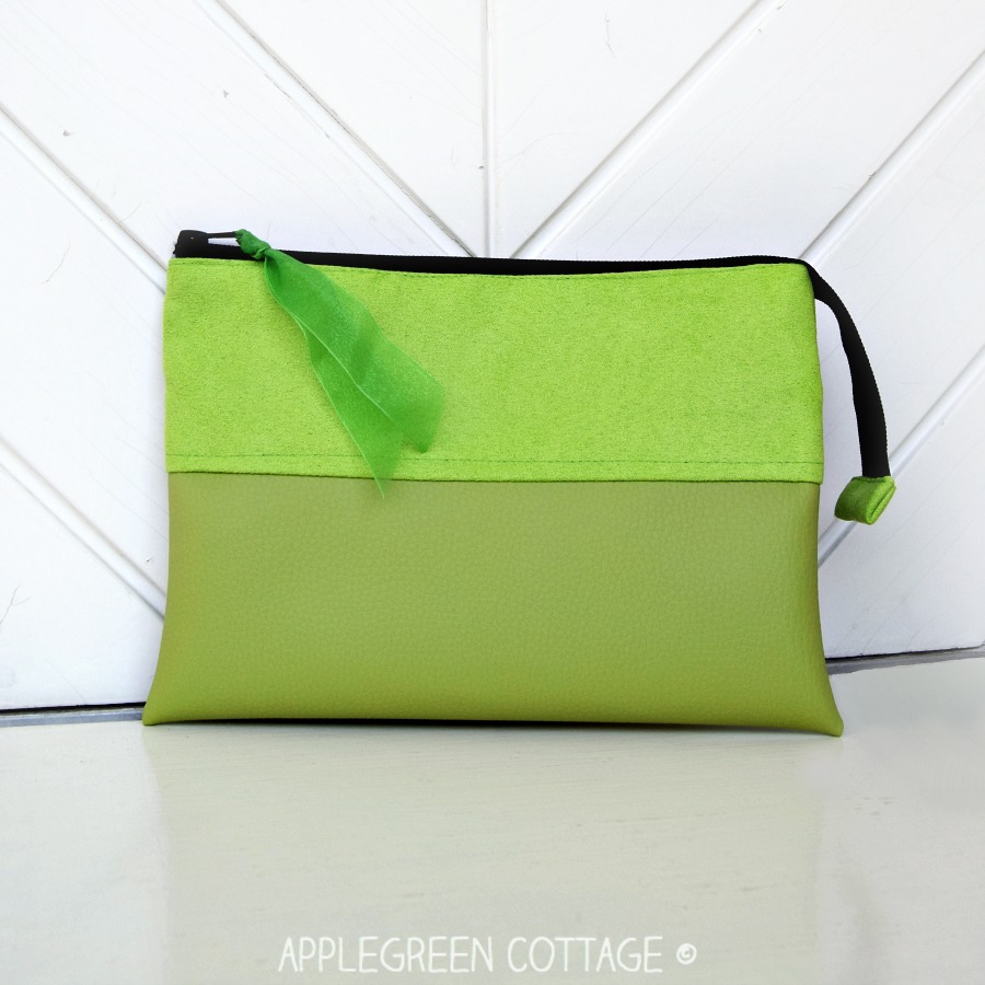 green pleather cosmetic case sewn with a free pattern and featuring a zipper that opens wide