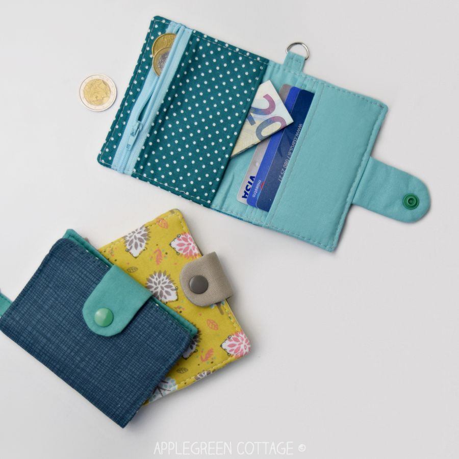 three small wallets sewn with fabric in yellow, blue, and teal prints