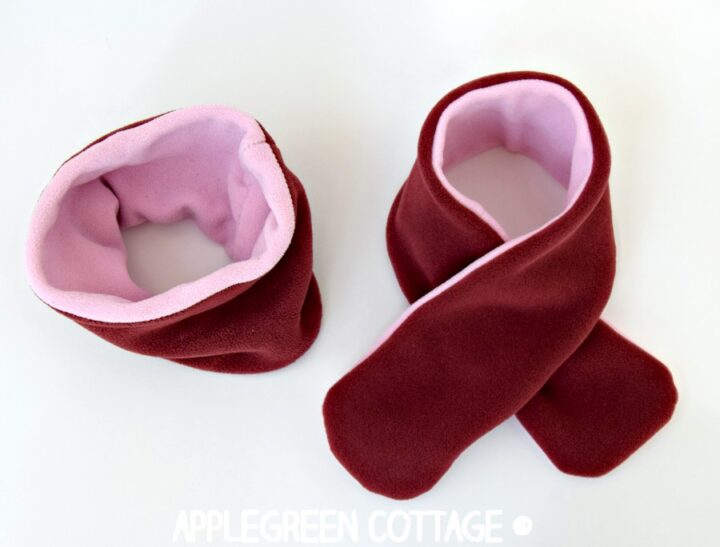 two finished scarves in red and pink: a cowl neck scarf and a classic fleece scarf
