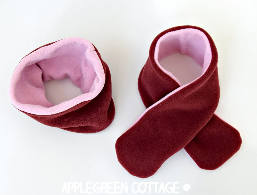 two finished scarves in red and pink: a cowl neck scarf and a classic fleece scarf