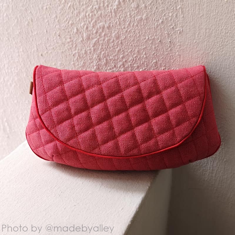 finished quilted purse sewn in red fabric using an elegant purse sewing pattern