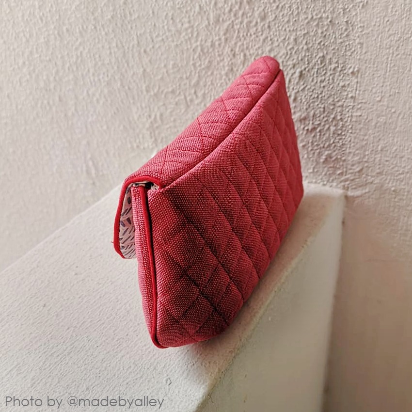 handmade red purse with a flap and piping accents