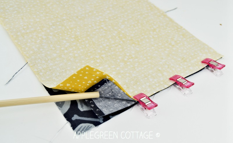 layering the fabric pieces to sew a drawstring bag