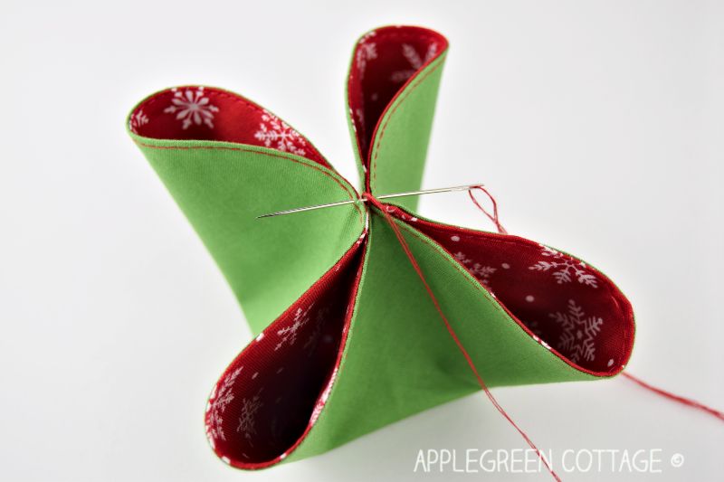 stitches on the red and green fabric origami ornament