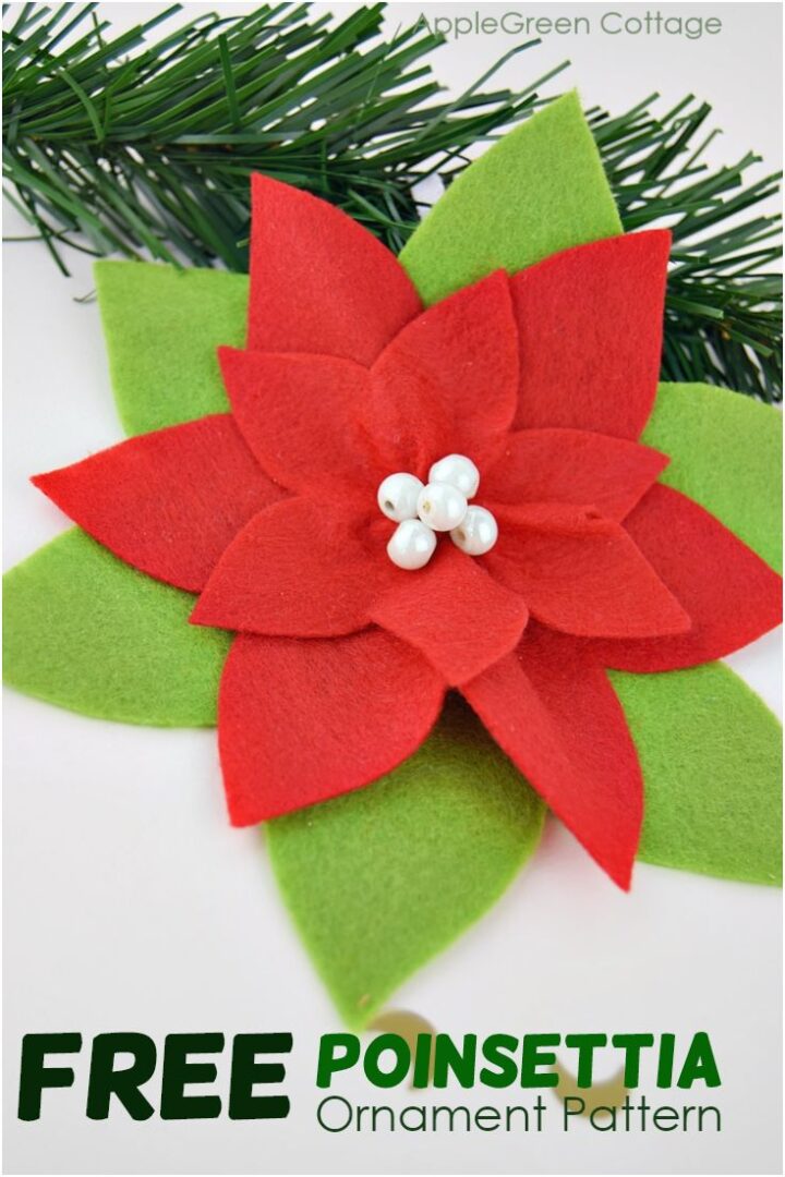 a handmade poinsettia ornament in red and green felt, with pearls attached to the middle