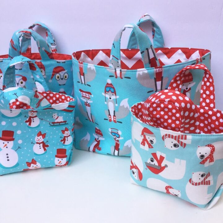 three handmade gift bags sewing with a winter-themed, aqua and red quilting cotton