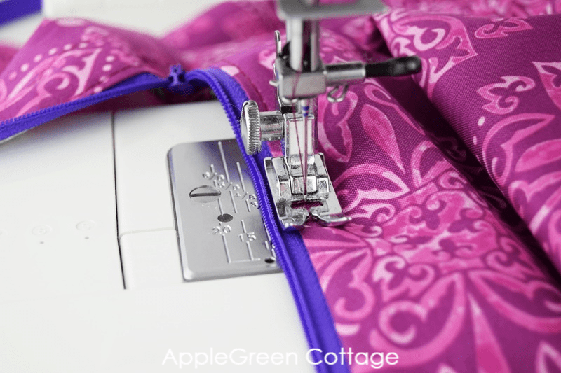 sewing zipper on a sewing machine with violet No 3 zipper and fabric in fuchsia print