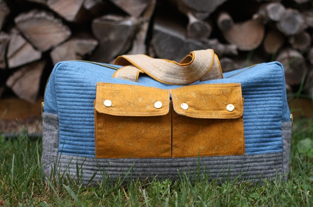 a finished handmade duffle bag in denim and with rustic background