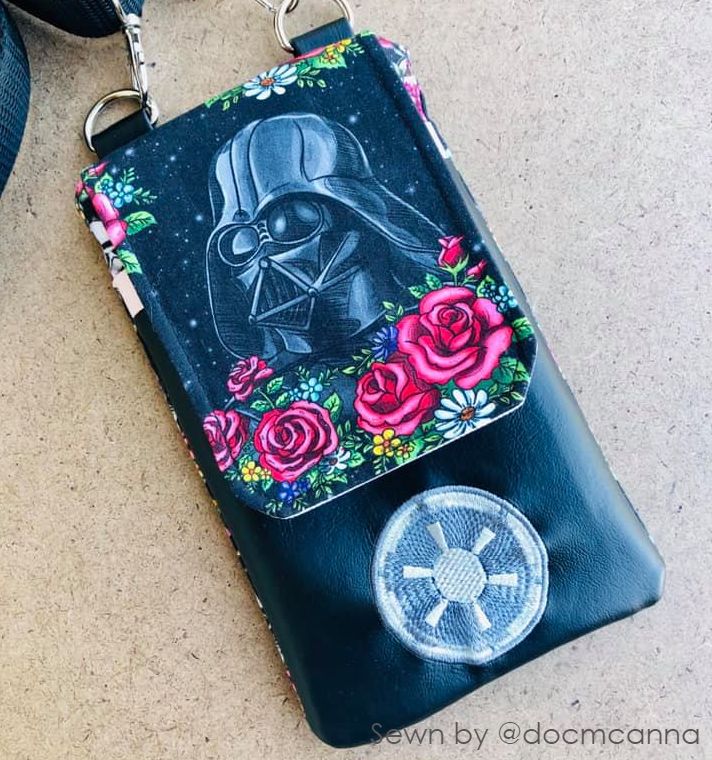 a handmade cell phone purse with a star wars embroidery and a flap featuring a star wars print