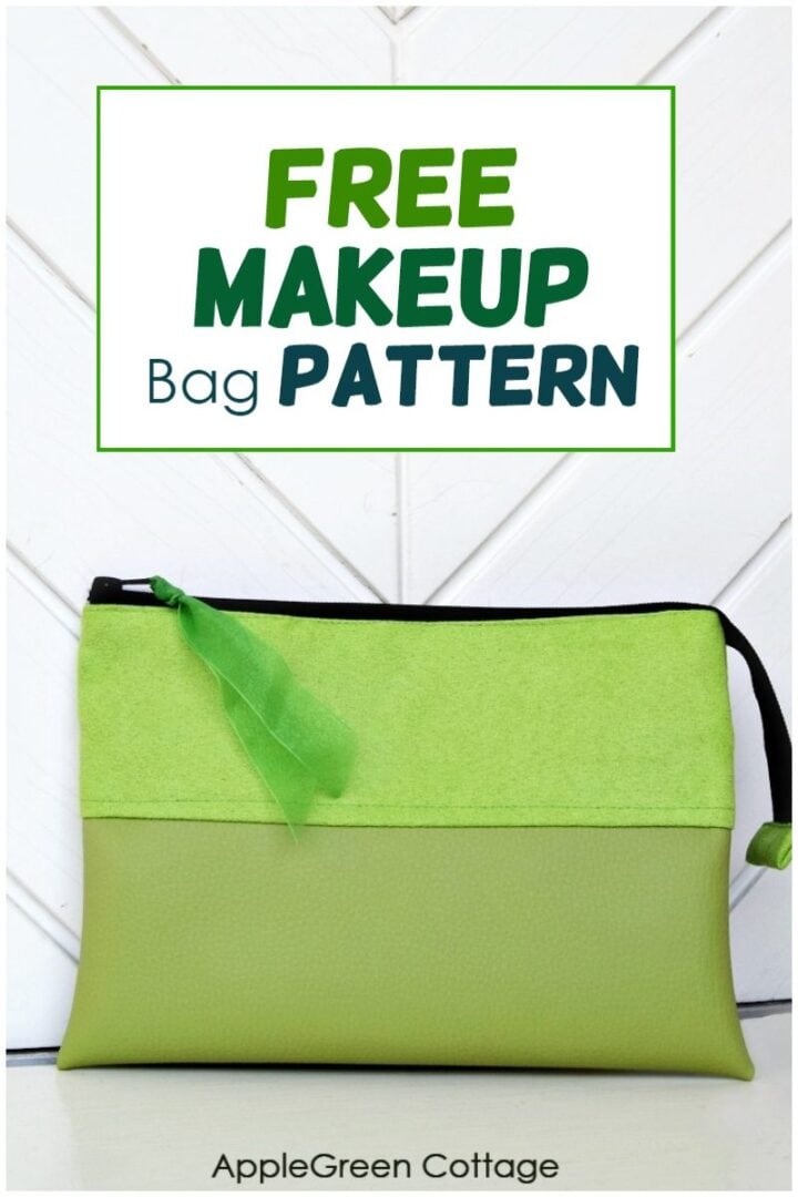 a finished cosmetic bag sewn with green faux leather and faux suede, propped against a white wall