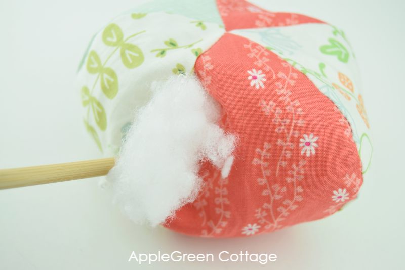 stuffing the fabric pumpkin using poly fill