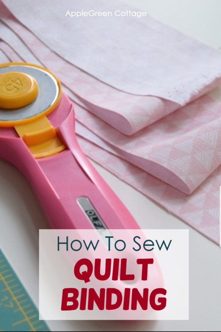 a rotary cutter next to a cut fabric stripe for quilt binding