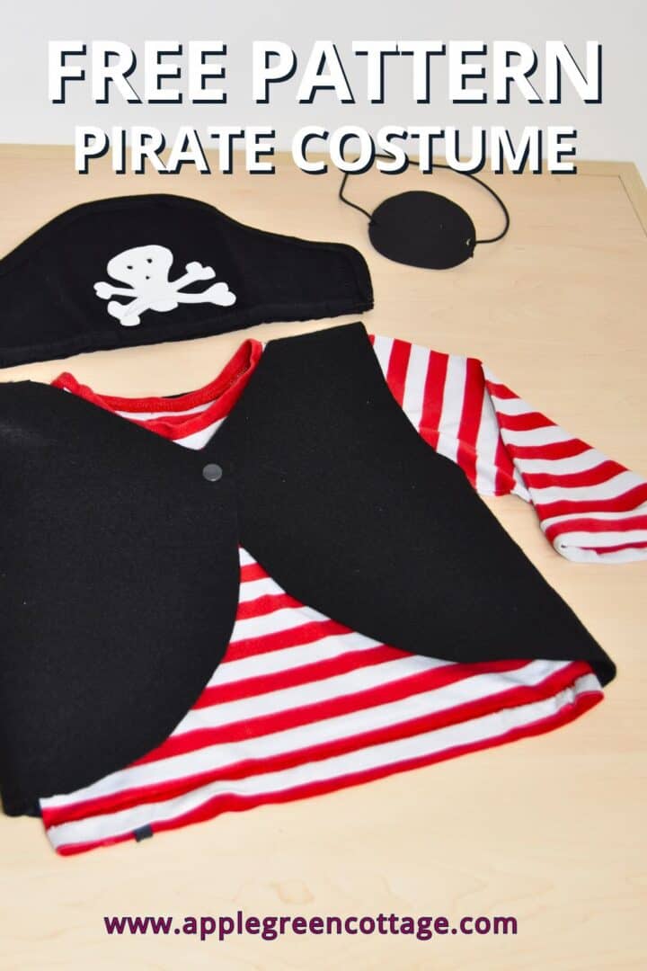 a completed homemade pirate costume with a pirate vest, a pirate cap, and a pirate eye patch, laid out on a wooden table