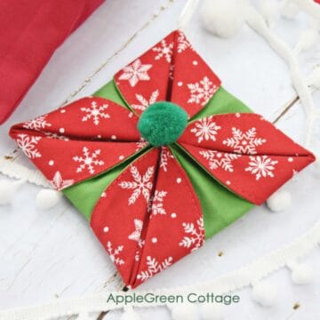 a finished fabric origami ornament in red and green