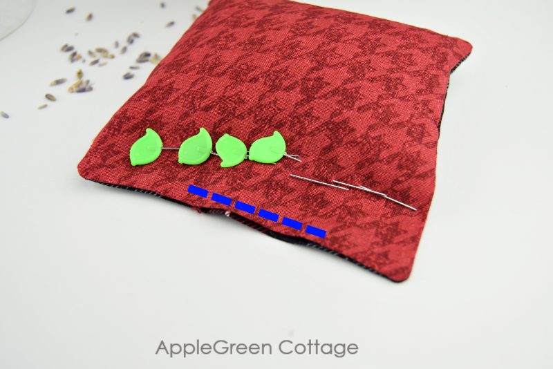 green pins on a semi finished square hand warmer