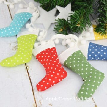 small sewn stockings in rainbow colors and a polka dot fabric prints arranged into a circle