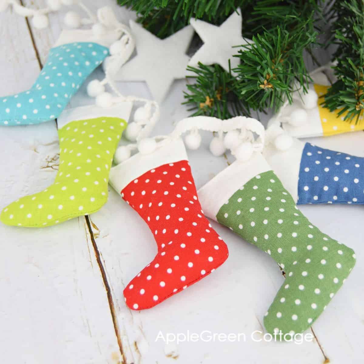 small sewn stockings in rainbow colors and a polka dot fabric prints arranged into a circle