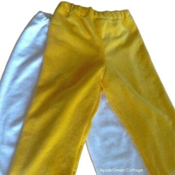 two finished pieces of pajama pants for kids sewn on a domestic sewing machine using minky fabric.