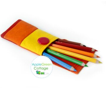 A finished orange and yellow felt pencil case with coloring pencils, sewn using applegreencottage tutorial.