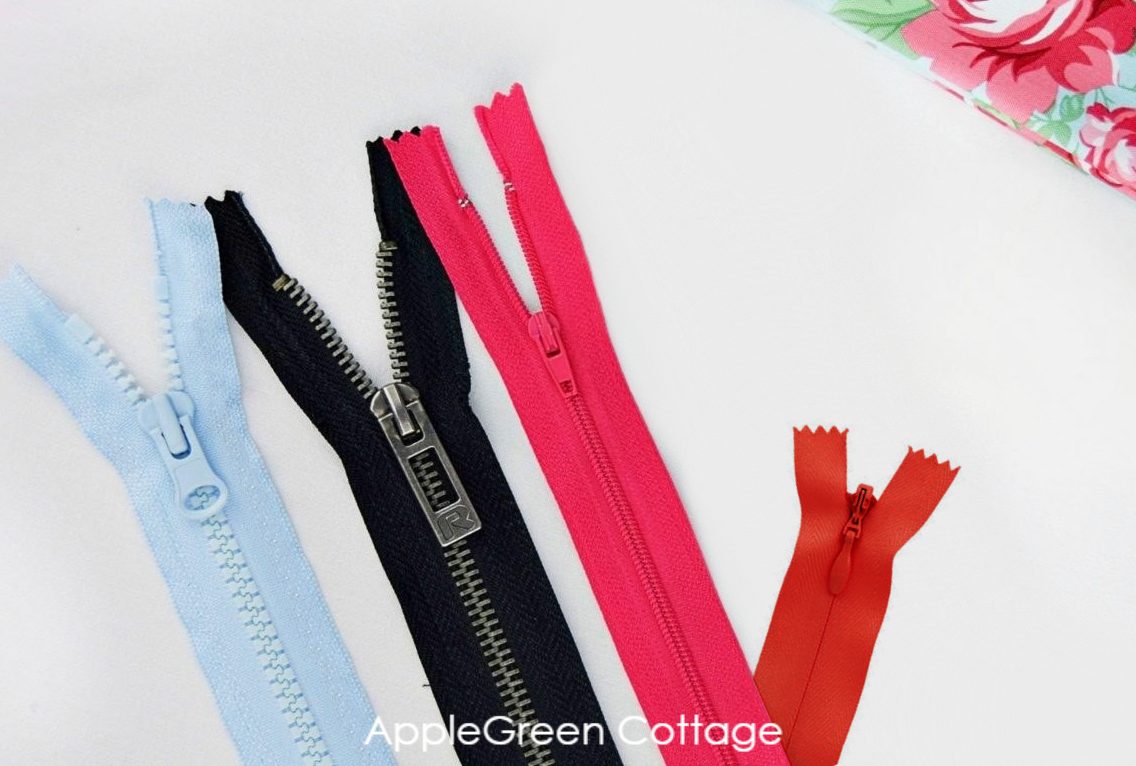 different types of zippers shown on a white surface