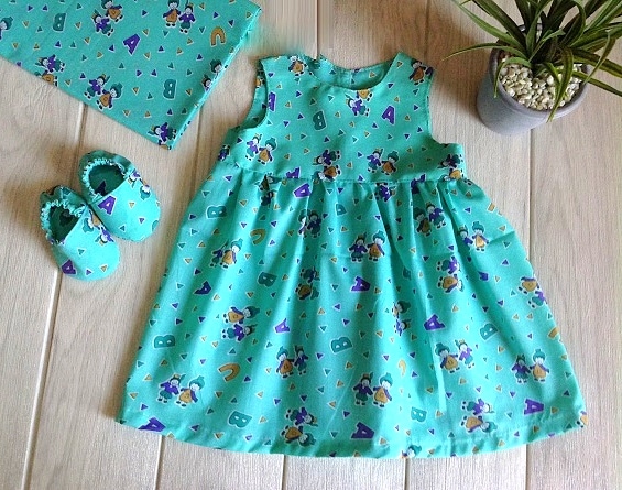 blue baby girl dress sewn with a free baby dress pattern