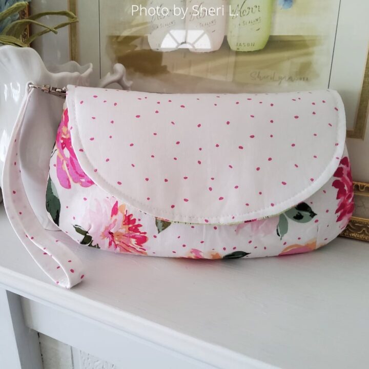 a finished Glam Girl purse with a wristlet strap sewn with light floral cotton print 
