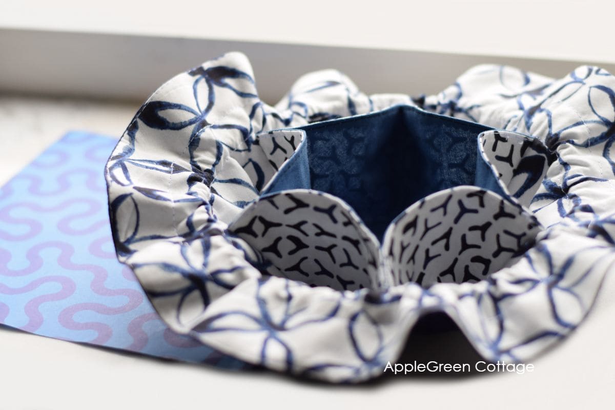 diy dice bag with dividers and drawstring in blue and white fabric on a table