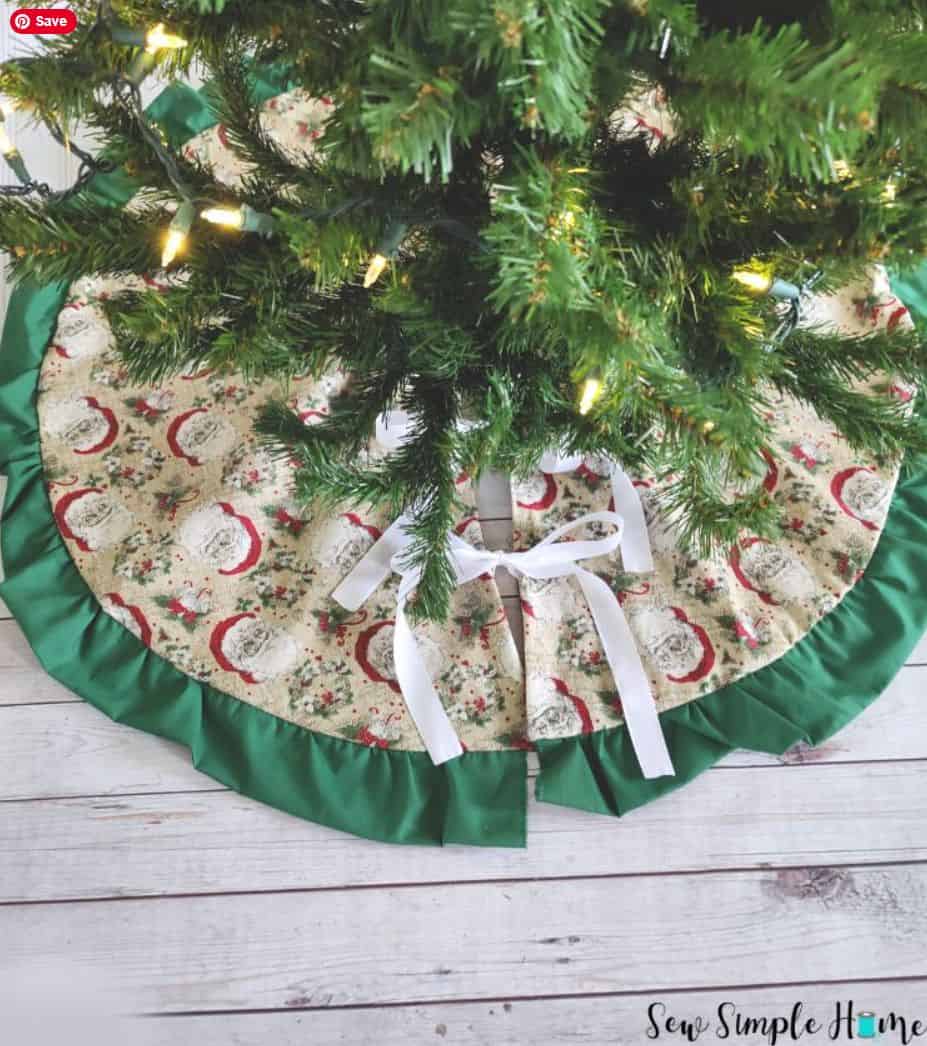 A simple, reversible fabric tree skirt with a green fabric trim and a holiday print.