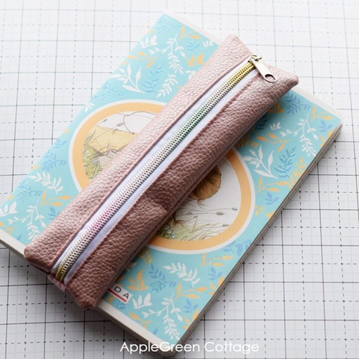 finished pencil case attached to a notebook with an elastic band