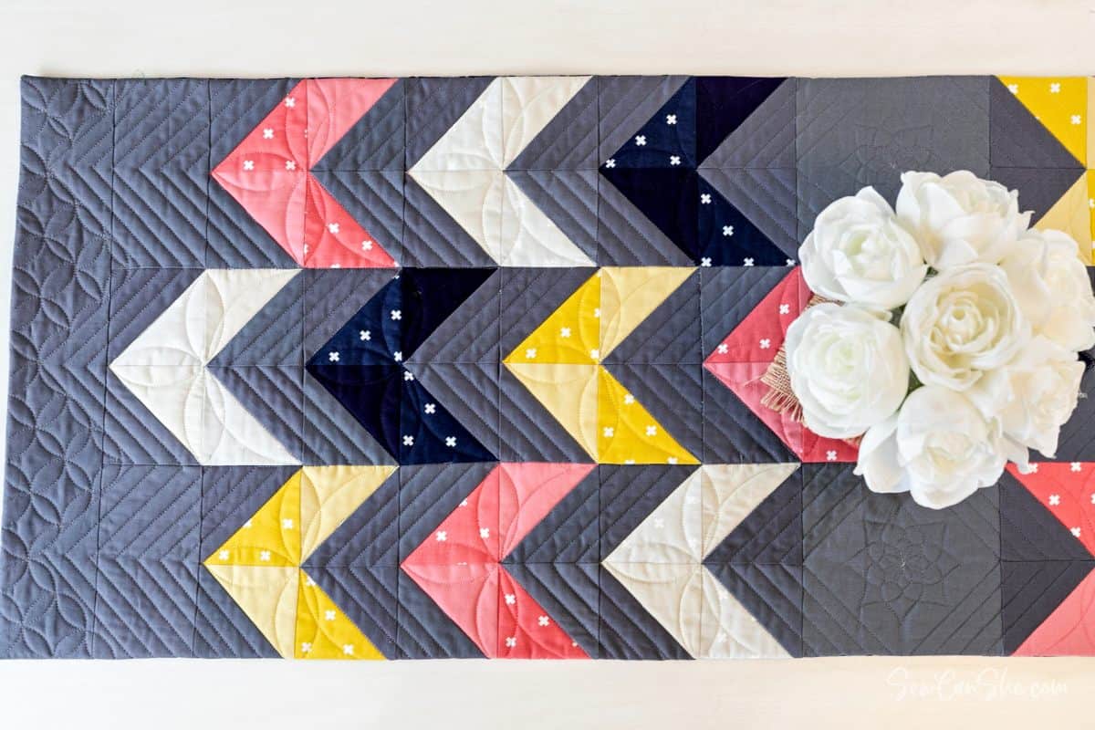 modern grey color blocked table runner with a floral bouquet